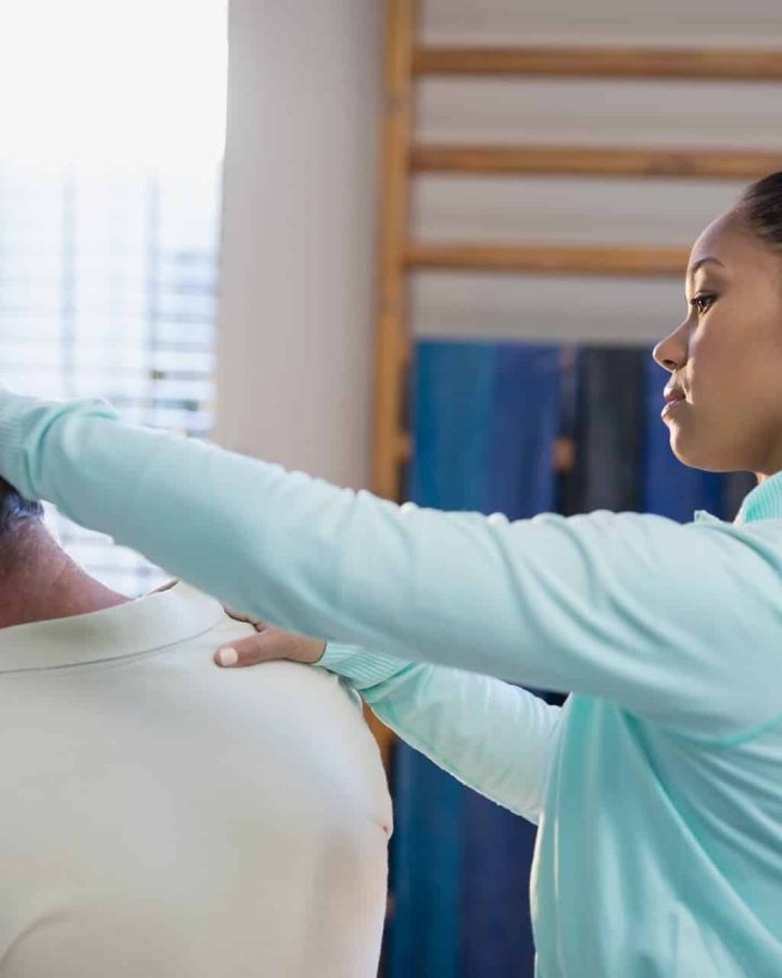 female therapist examining neck of senior male pat 2023 11 27 05 36 20 utc
