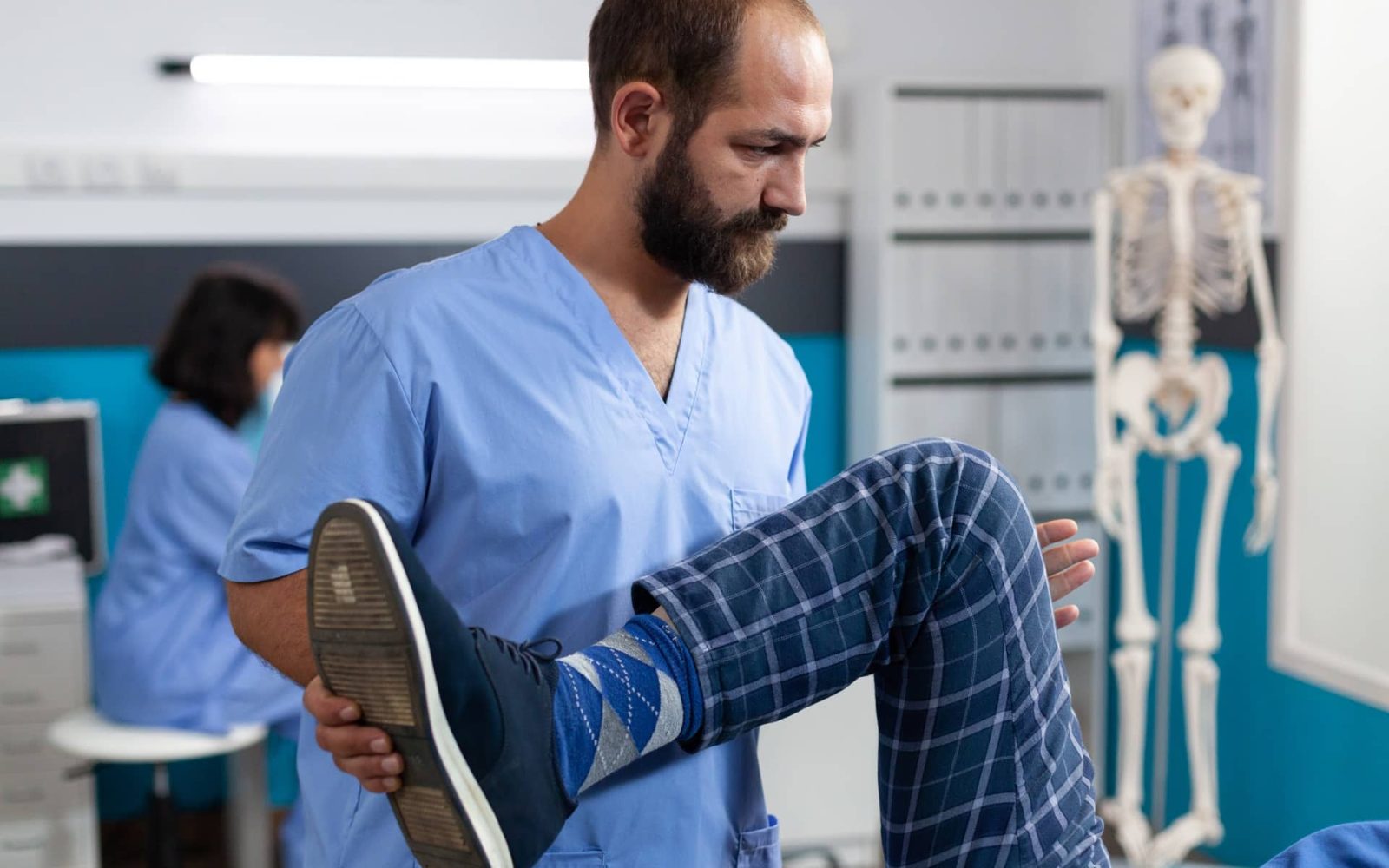 chiropractor stretching leg of retired patient for 2023 11 27 04 58 41 utc