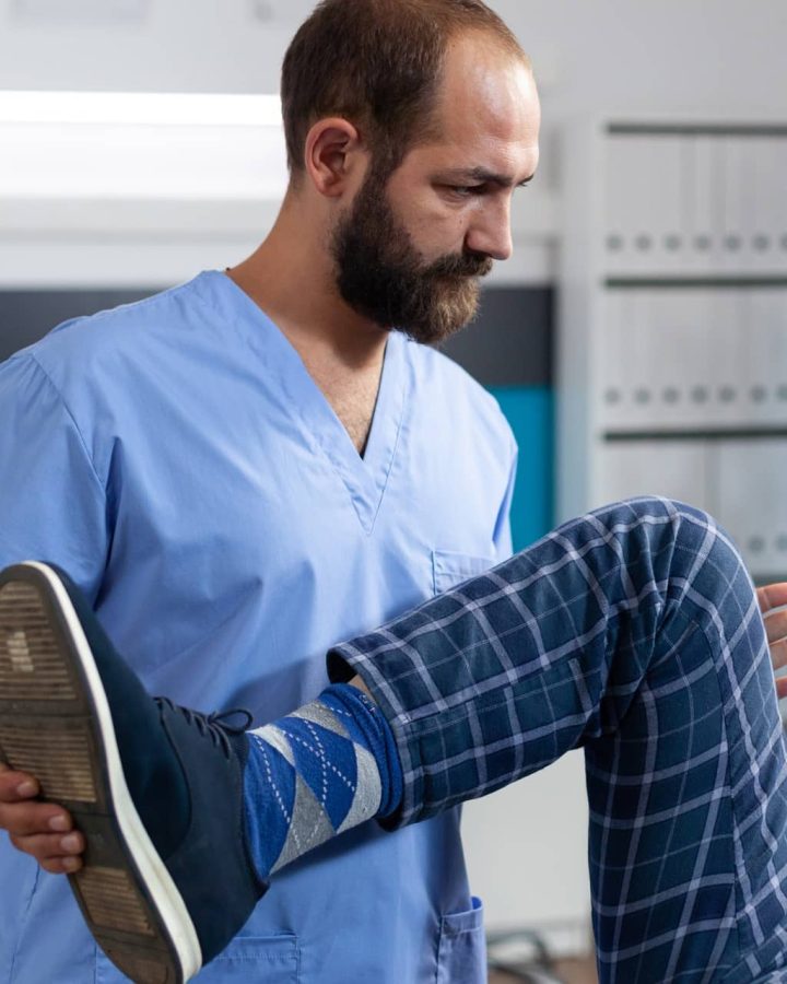 chiropractor stretching leg of retired patient for 2023 11 27 04 58 41 utc