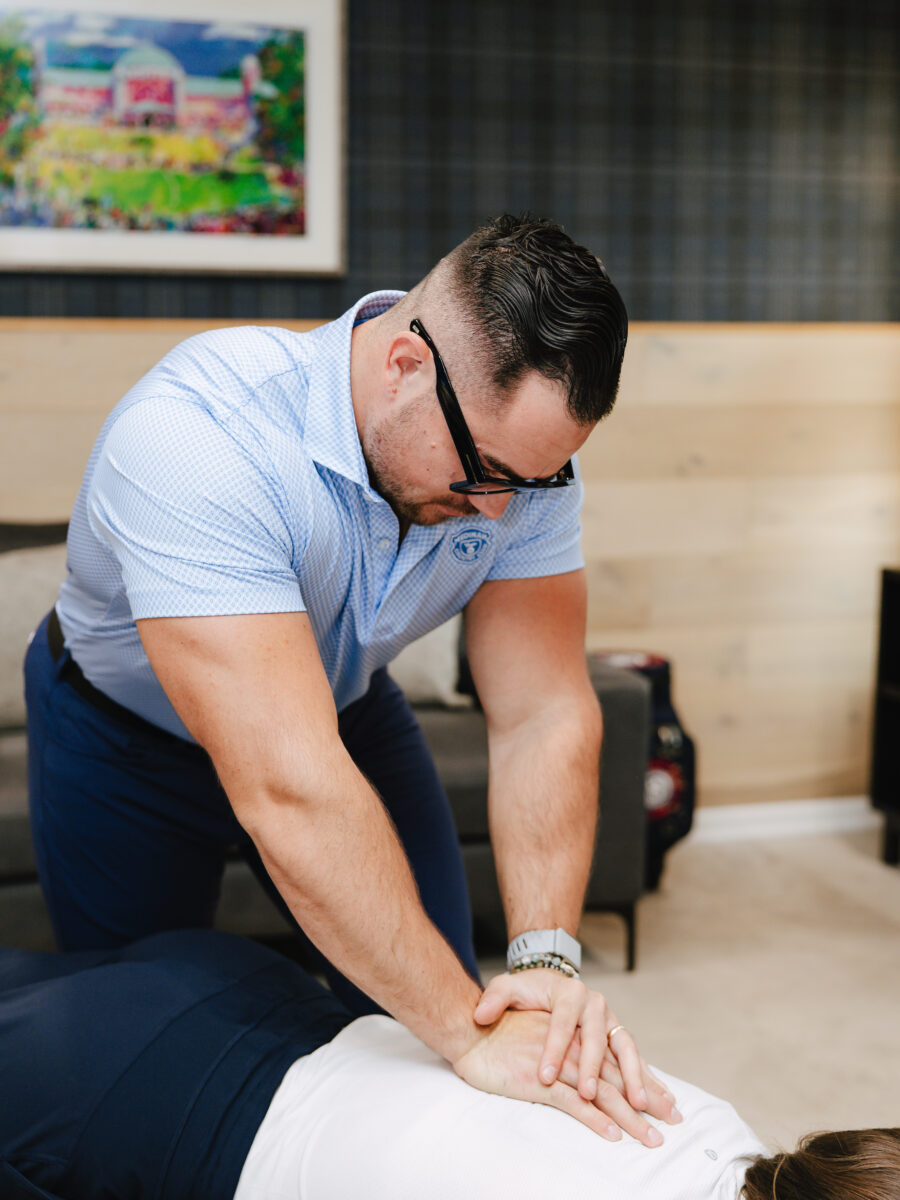 Chiropractor performing a table-assisted chiropractic adjustment
