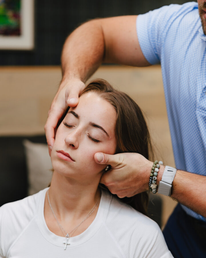Gentle hands-on head and neck assessment at Forza Chiropractic