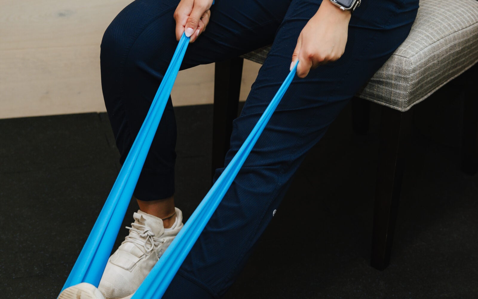 Guided resistance band leg exercise during rehab at Forza Chiropractic
