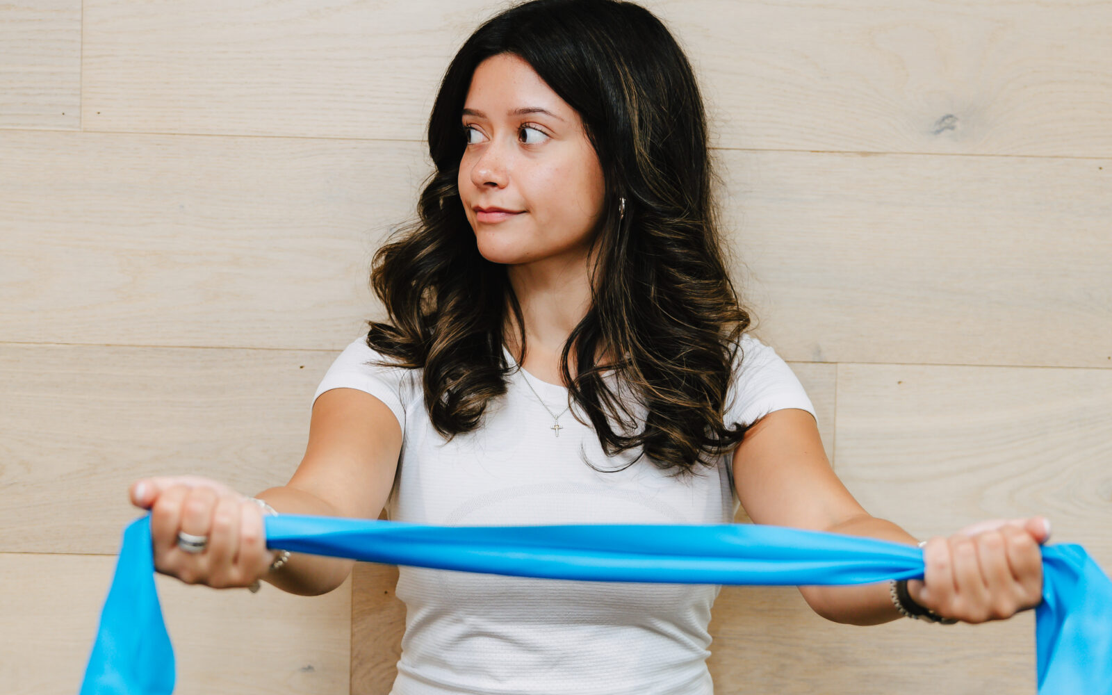 Patient performing a resistance band stretch for posture strengthening