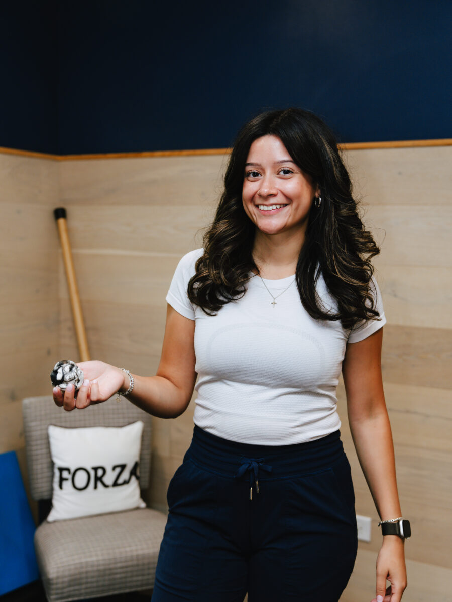 Forza Chiropractic team member demonstrating spinal anatomy with a model