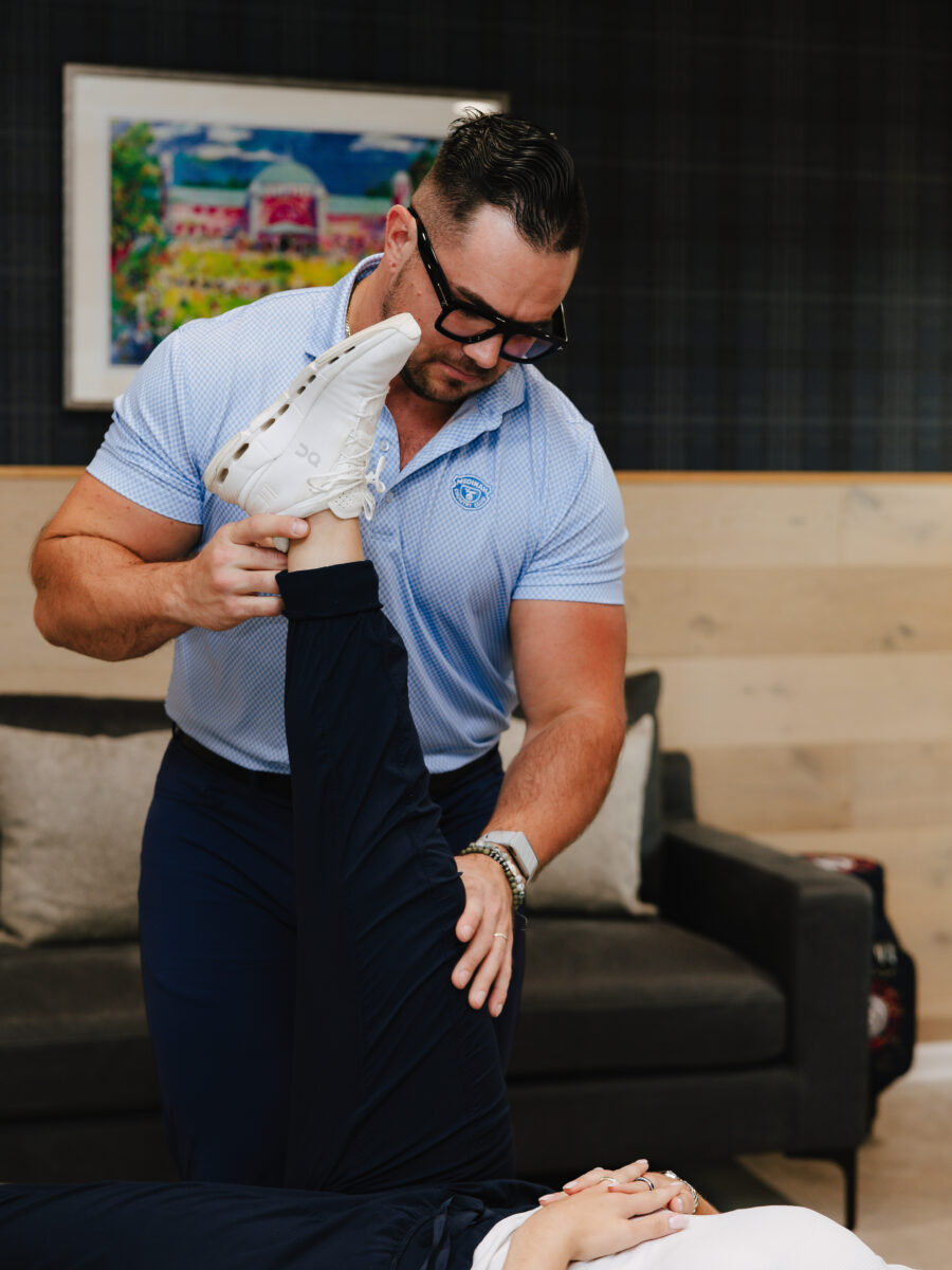Chiropractor demonstrating corrective care equipment at Forza Chiropractic