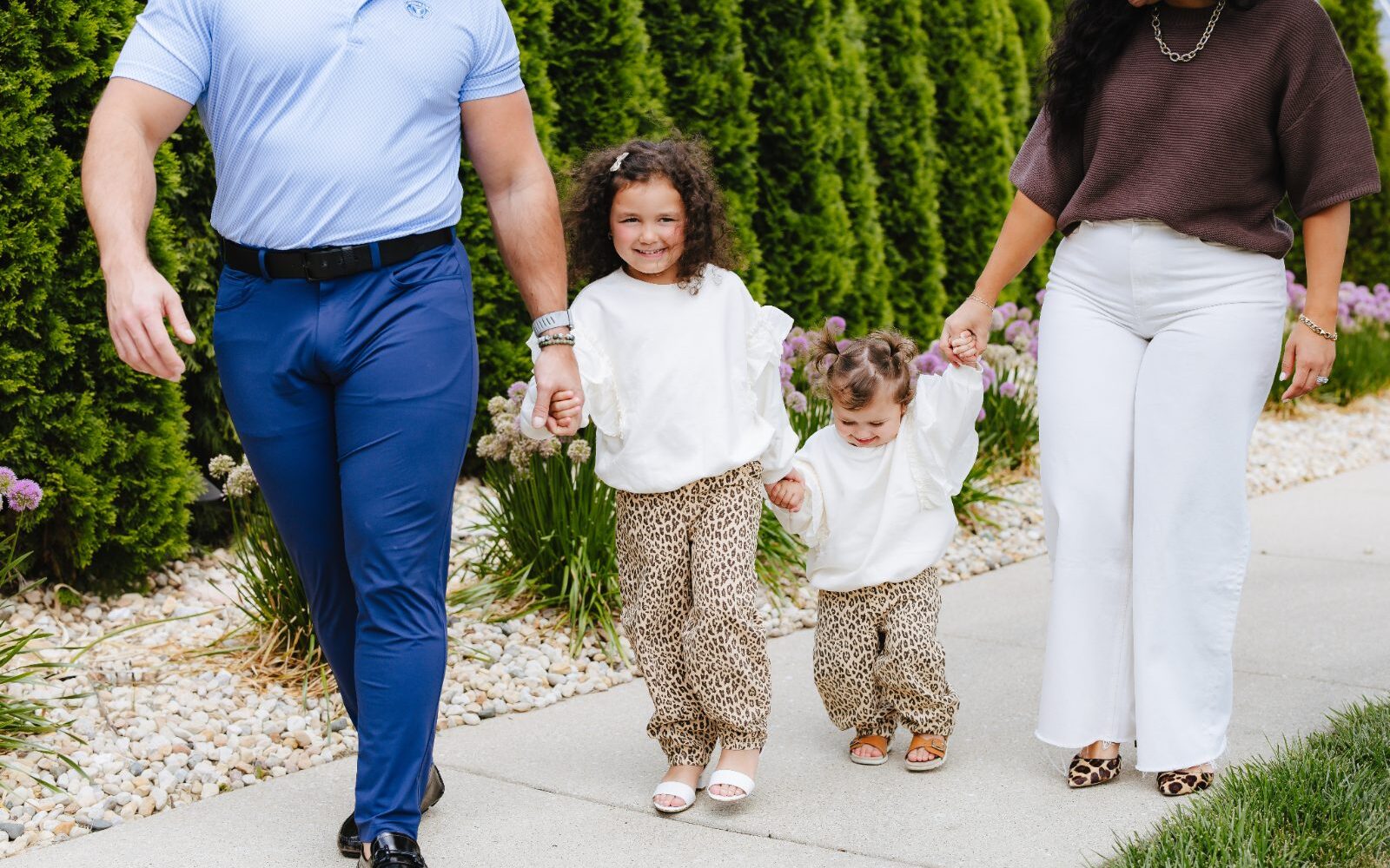 Dr. Drew Voelsch walking outdoors with his family near Arlington Heights
