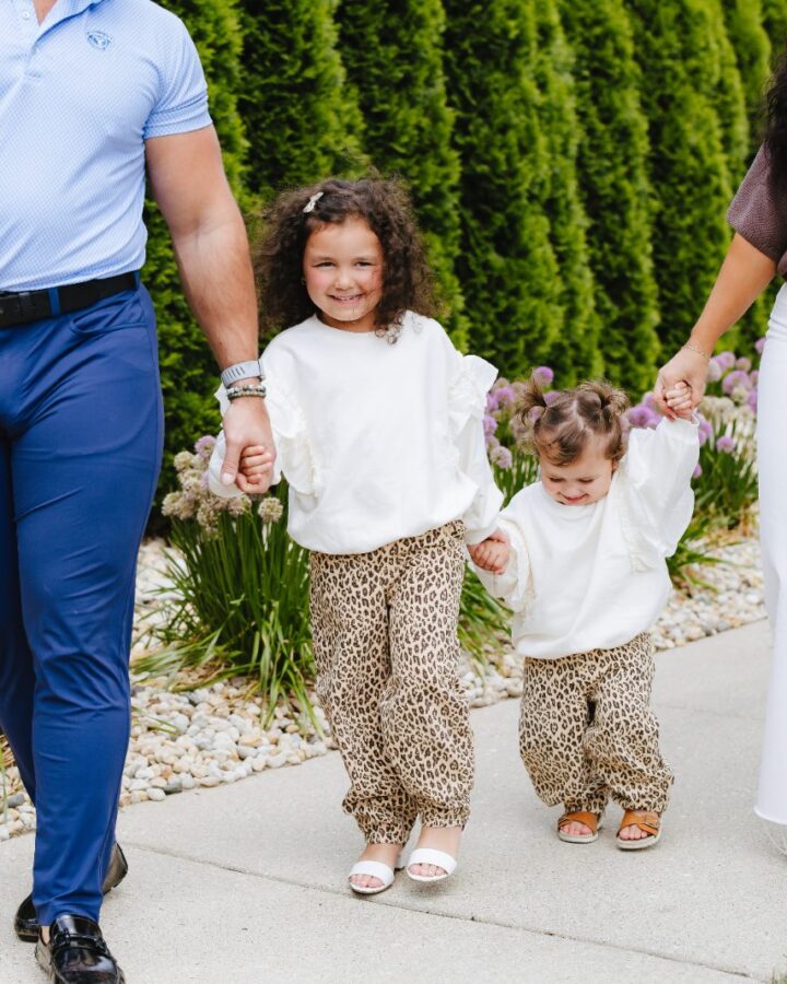 Dr. Drew Voelsch walking outdoors with his family near Arlington Heights