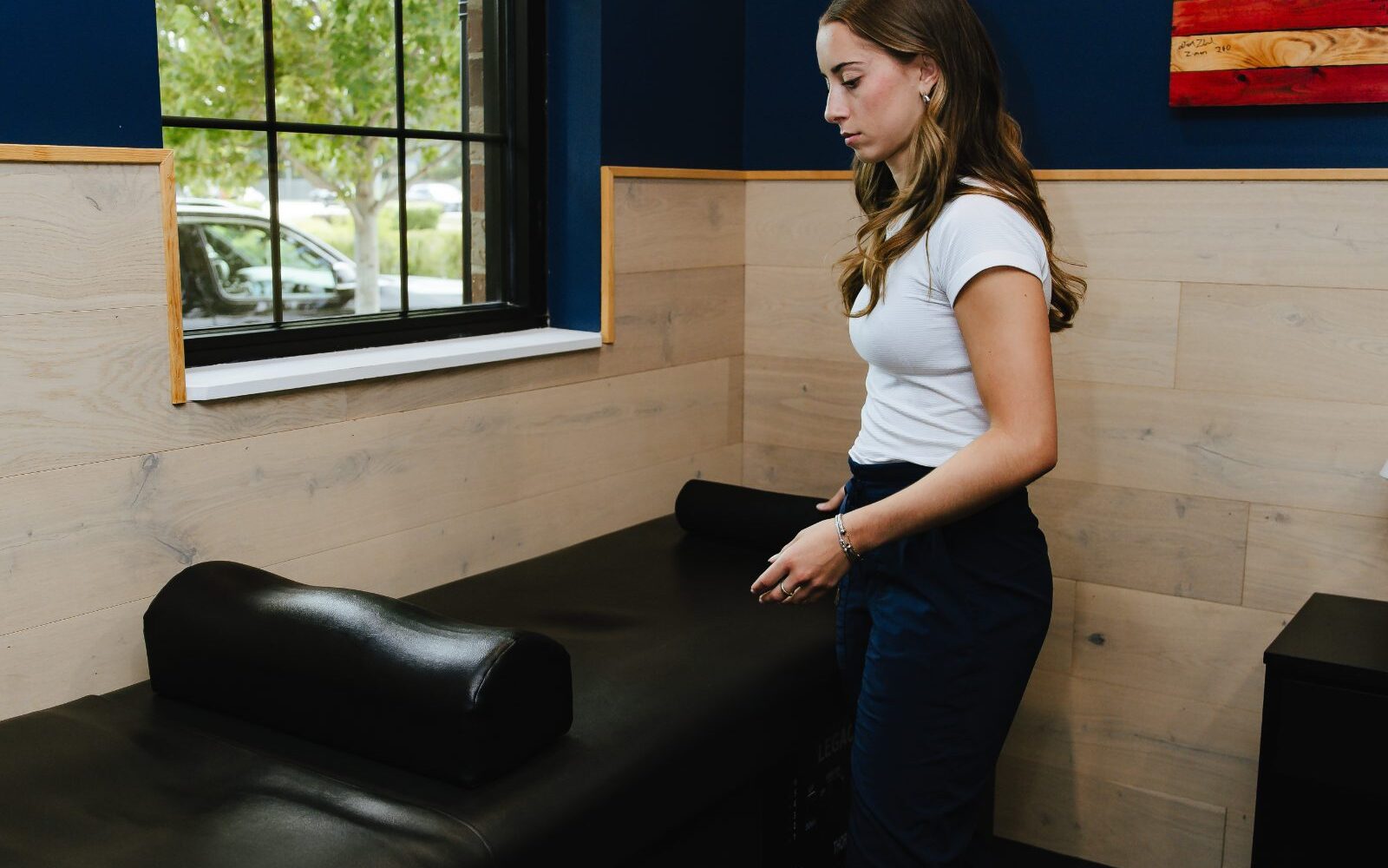 Patient seated on a treatment table at Forza Chiropractic in Arlington Heights